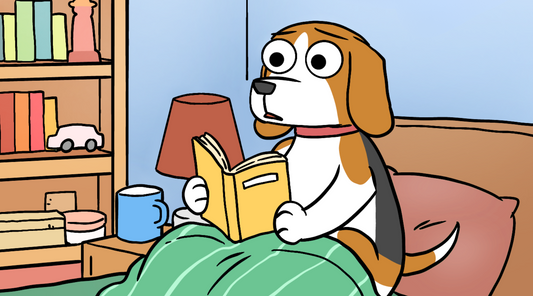 A dog reading a book in bed missing his best friend