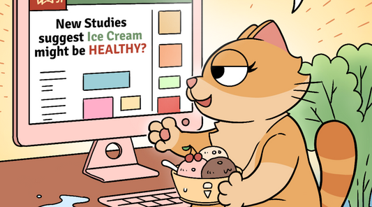 Close-up of Duchess the cat looking pleased with herself, holding a bowl of ice cream while reading "New Studies suggest Ice Cream might be HEALTHY?" on her computer screen