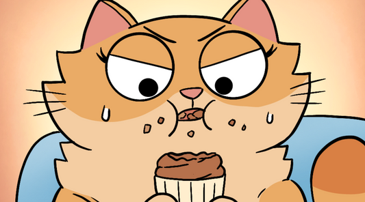 Duchess the cat is eating a cupcake and deciding whether she is going to eat it or not