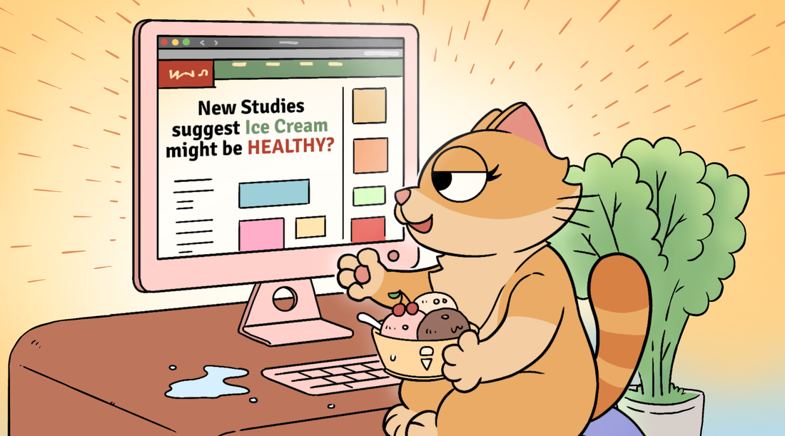 A smug cartoon cat sits at her desk eating a bowl of ice cream, delighted by a headline on her screen proving confirmation Bias makes us eagerly accept information that confirms what we already want to believe
